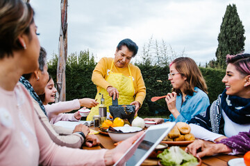 latin grandmother and granddaughter, daughter cooking mexican food at home, three generations of women in Mexico