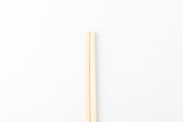 Disposable wooden chopsticks on a white background