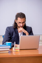 Young male teacher in the classroom