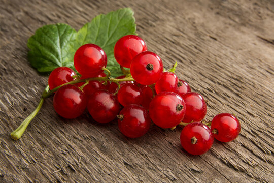 red currants on a wooden table