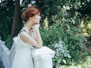 Attractive woman in white dress fresh air green leaves