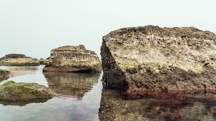 Fototapeta na wymiar Rocky sea beach with boulders