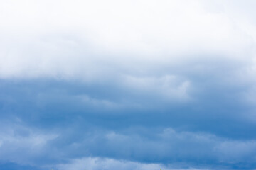 Cumulus clouds, dramatic dark blue summer sky of bad weather, thunderstorm beginning of heavy rain at autumn