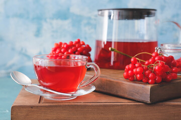 Cup of healthy viburnum tea on table
