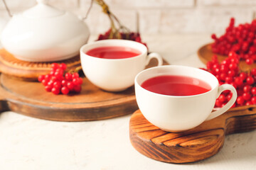 Cup of healthy viburnum tea on table