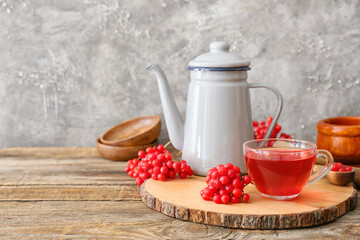 Cup of healthy viburnum tea on table