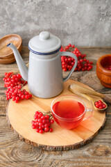 Cup of healthy viburnum tea on table