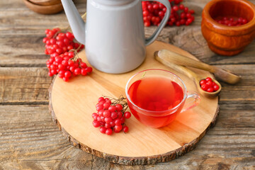 Cup of healthy viburnum tea on table