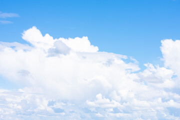 Natural background made of daylight blue sky and fluffy white cumulus clouds