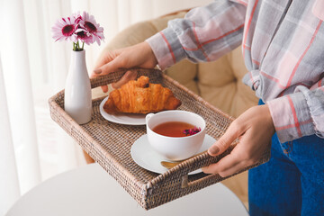 Obraz na płótnie Canvas Woman holding tray with tasty breakfast in room, closeup
