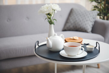 Tray with tasty breakfast on table in room