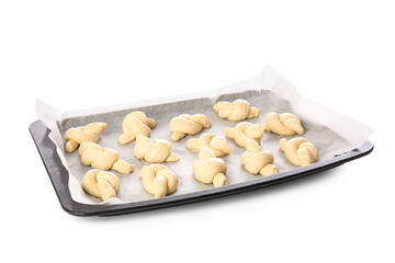 Baking sheet with uncooked garlic buns on white background