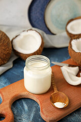 Fototapeta na wymiar Jar of tasty coconut yogurt on color background