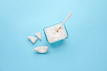 Tasty coconut yogurt on color background