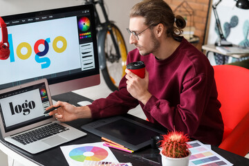Young male designer working in office