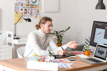 Young male designer working in office