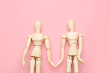 Wooden mannequins on color background