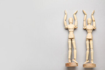 Wooden mannequins on grey background