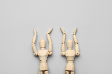 Wooden mannequins on grey background
