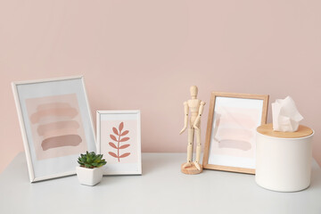 Stylish decor on table near color wall