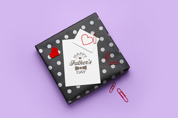 Gift box and greeting card for Father's Day celebration on color background