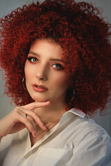 White European girl with afro curls, beautiful casual makeup. Large portrait of a girl with red hair