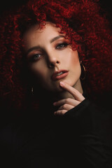 White European girl with afro curls, beautiful casual makeup. Large portrait of a girl with red hair