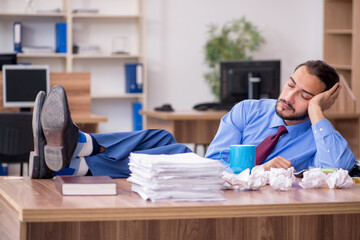 Young male employee in brainstorming concept