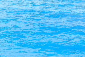 Abstract photo of surface motion water of sea or ocean with beautiful sky blue light tone.