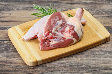 Raw duck leg served rosemary