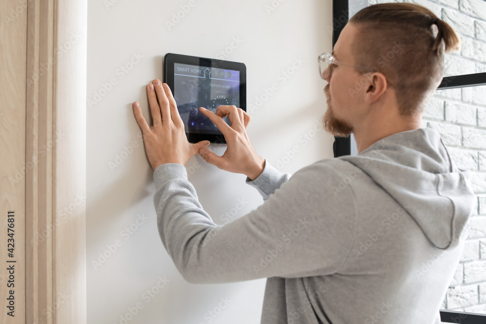 Poster man using smart home security system control panel