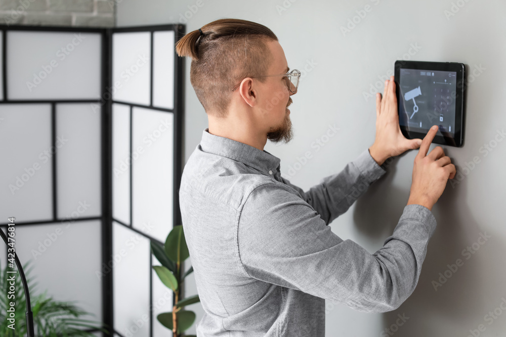 Poster man using smart home security system control panel