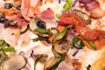 Italian pizza with ham, cherry tomatoes, pepper and champignon mushrooms. Close up