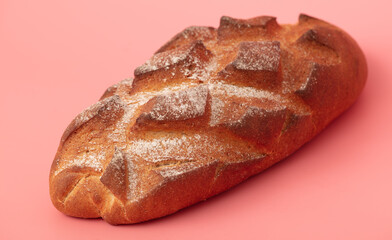 Fresh bread isolated on a pink background.