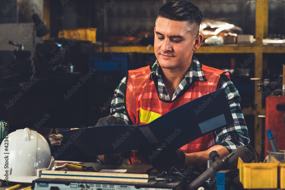 Poster manufacturing worker working with clipboard to do job procedure checklist . factory production line 