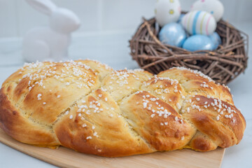 Sweet home made braided yeast bun for easter on a table