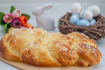 Sweet home made braided yeast bun for easter on a table