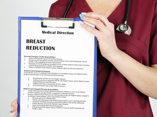 Healthcare concept meaning BREAST REDUCTION with phrase on the piece of paper.