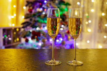 two glasses of champagne against the backdrop of the Christmas tree