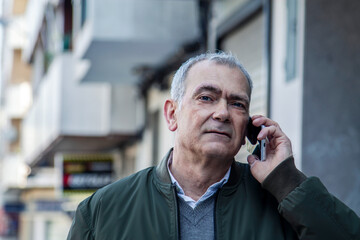 adult man using the phone on the street