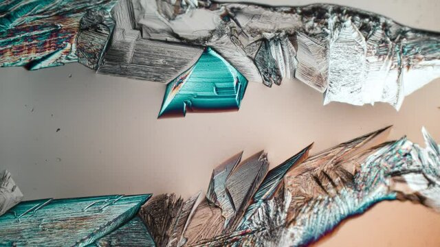 Time-lapse of crystallization Magnesium sulfate or Epsom Salt under polarized light. Formation of crystals under the microscope. 