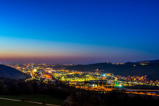 Germany, Magical sunset sky above houses, roofs and buildings near  neckar river of stuttgart city at dawning from above with glowing lights and starry sky