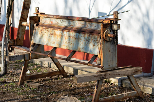 Metal bending device, sheets used in the metal processing and manufacturing industry. (Abkant) Old and rusty device.