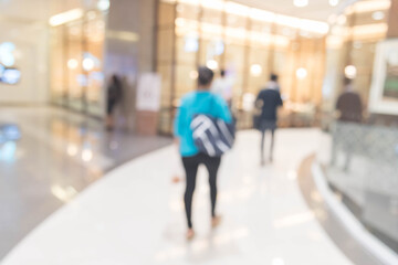 Abstract defocused or blurred background of the shopping mall with nice department store interior. which including of people and shop store.