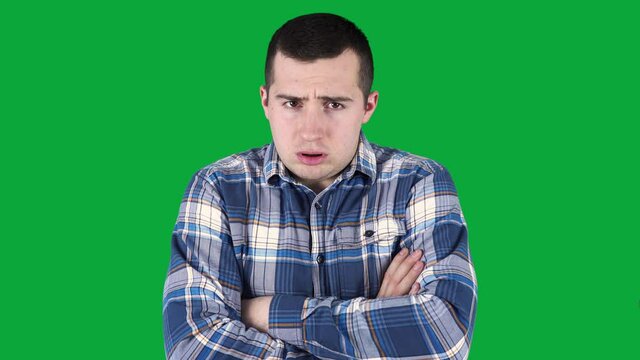 a man trying to keep warm by moving in place on a green screen.