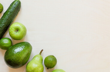 Fresh green fruits and vegetables on wooden table with copy space