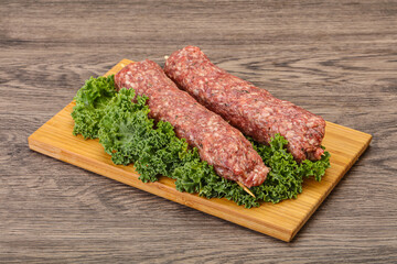Raw minced beef kebab skewer