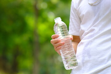 Bottle of water in green natural background and space