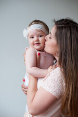 Happy mother kissing her smiling baby