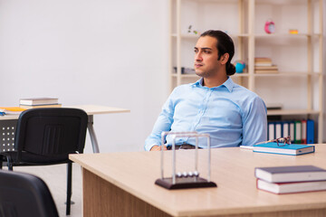Young male teacher in the classroom